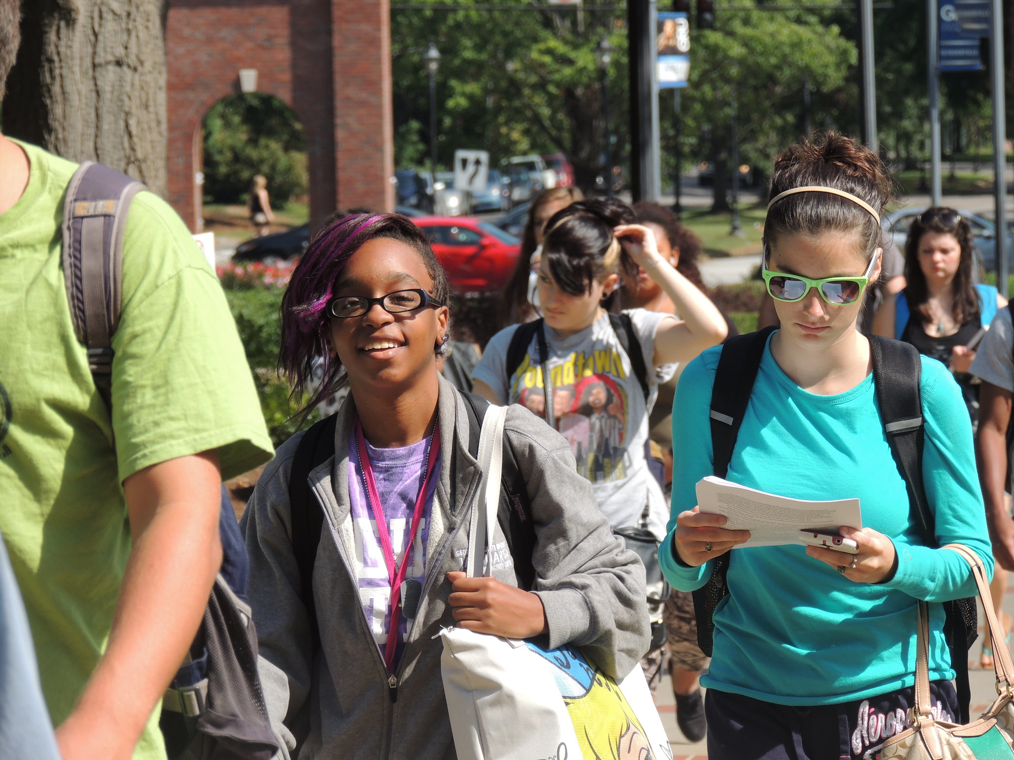 young black student wearing glasses and young white student wearing sunglasses